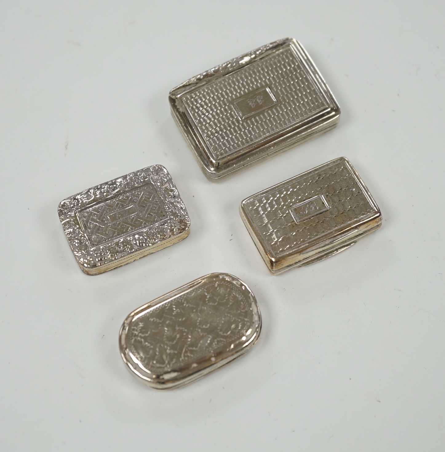 Four assorted 19th century silver vinaigrettes, including Joseph Wilmore, Birmingham, 1831, with engraved lattice work decoration, 32mm.